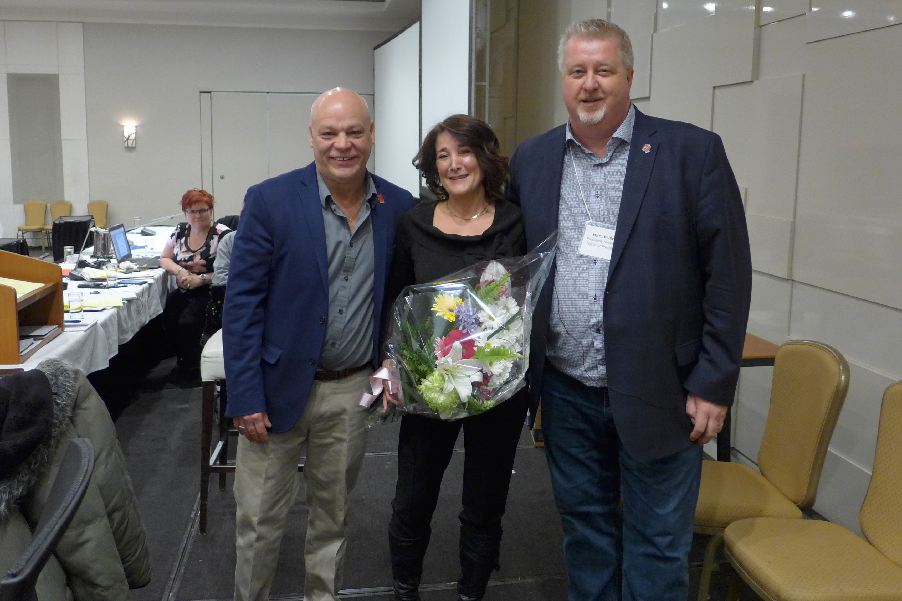 Lyson Paquette, Labour Relations Officer receives flowers on her last day of work.  Enjoy your retirement