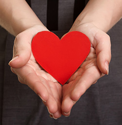 a red heart in hands