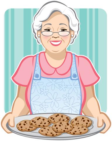 older woman holding a plate of cookies